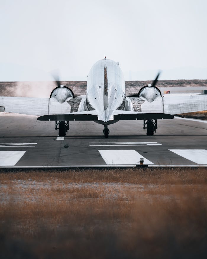 A twin-engine airplane prepares for takeoff on a runway, showcasing aviation technology.