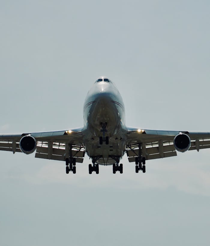 A passenger airplane taking off against a clear sky seen from the front.